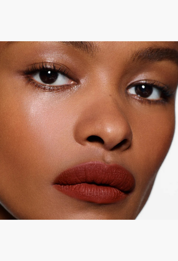 GLAM MODA Rouge Victoria matte red lipstick on a model with a touch of white cream on the lower lip