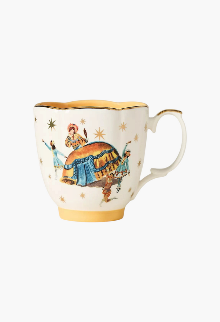 GLAM MODA stoneware mug featuring The Nutcracker ballet illustration with gold star accents and yellow trim.
