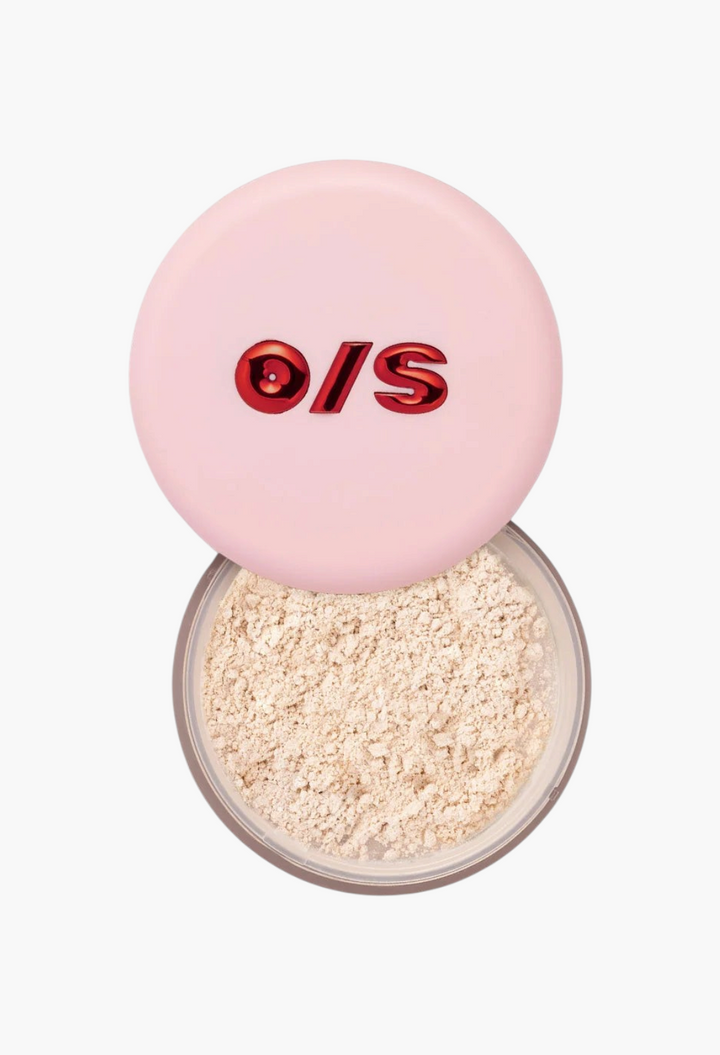 GLAM MODA Blurring Setting Powder Crystal Sprinkles in a round container with a light pink lid and golden shimmer.