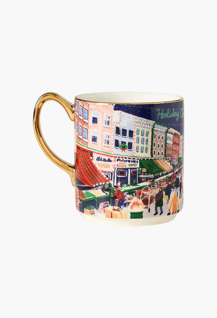 GLAM MODA Holiday in the City stoneware mug featuring a festive street scene with hand-painted gold handle and rim.