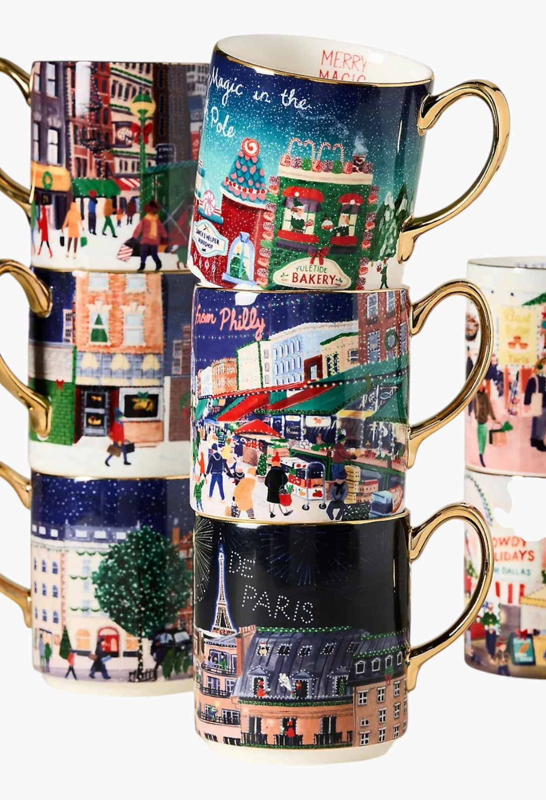GLAM MODA Holiday in the City stoneware mugs stacked, featuring festive streetscapes and hand-painted gold handles.