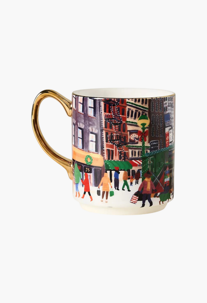 GLAM MODA Holiday in the City stoneware mug featuring a festive streetscape illustration and gold-painted handle.