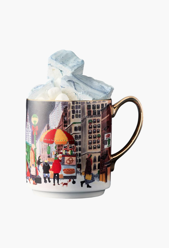 GLAM MODA Holiday in the City stoneware mug featuring a festive streetscape illustration and gold-painted handle.