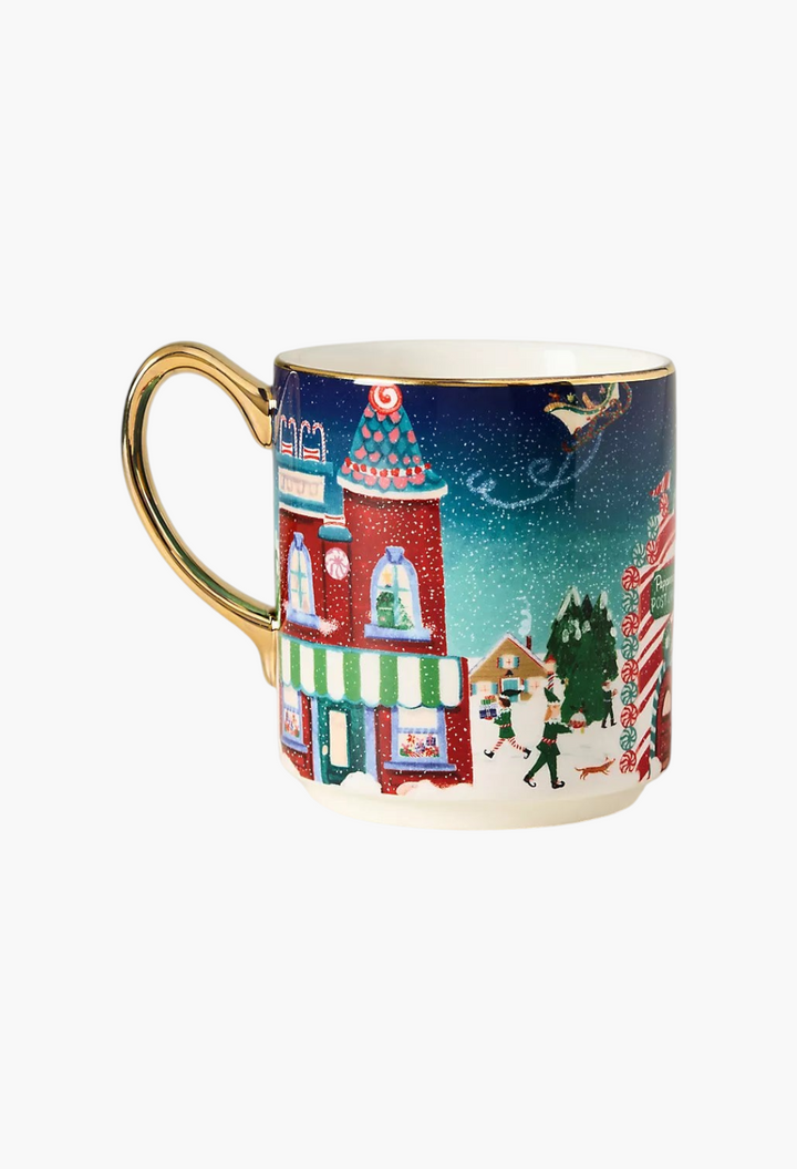 GLAM MODA Holiday in the City stoneware mug featuring a festive snowy streetscape, gold handle, and painted accents.