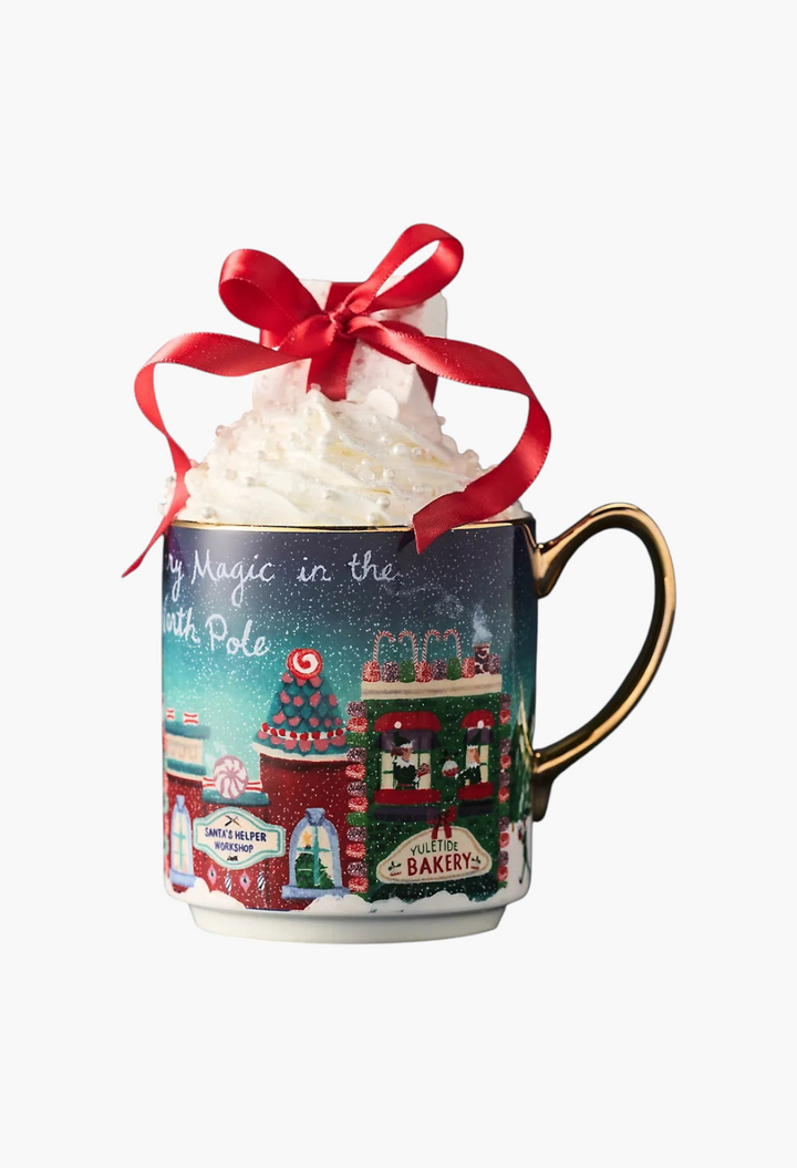 GLAM MODA Holiday in the City stoneware mug featuring a festive streetscape, gold handle, and whipped cream topping.
