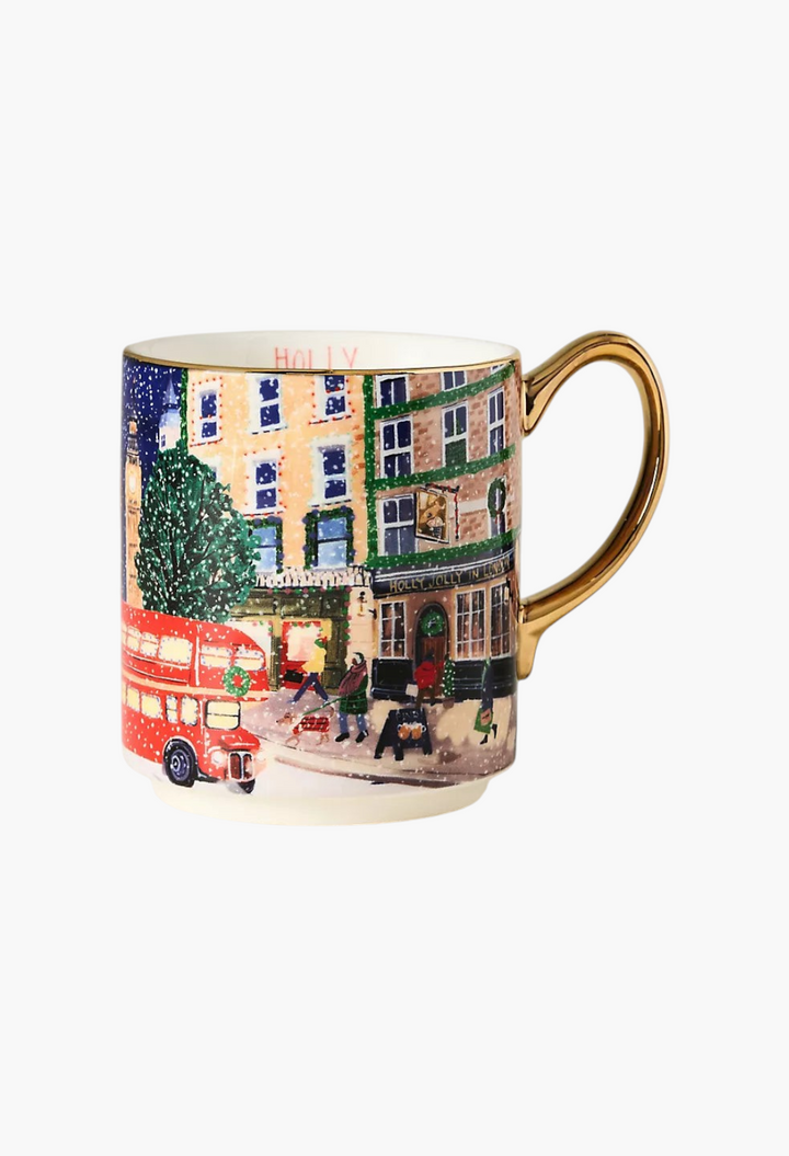 GLAM MODA stoneware mug featuring a festive city street scene with a red bus and hand-painted gold handle and rim.