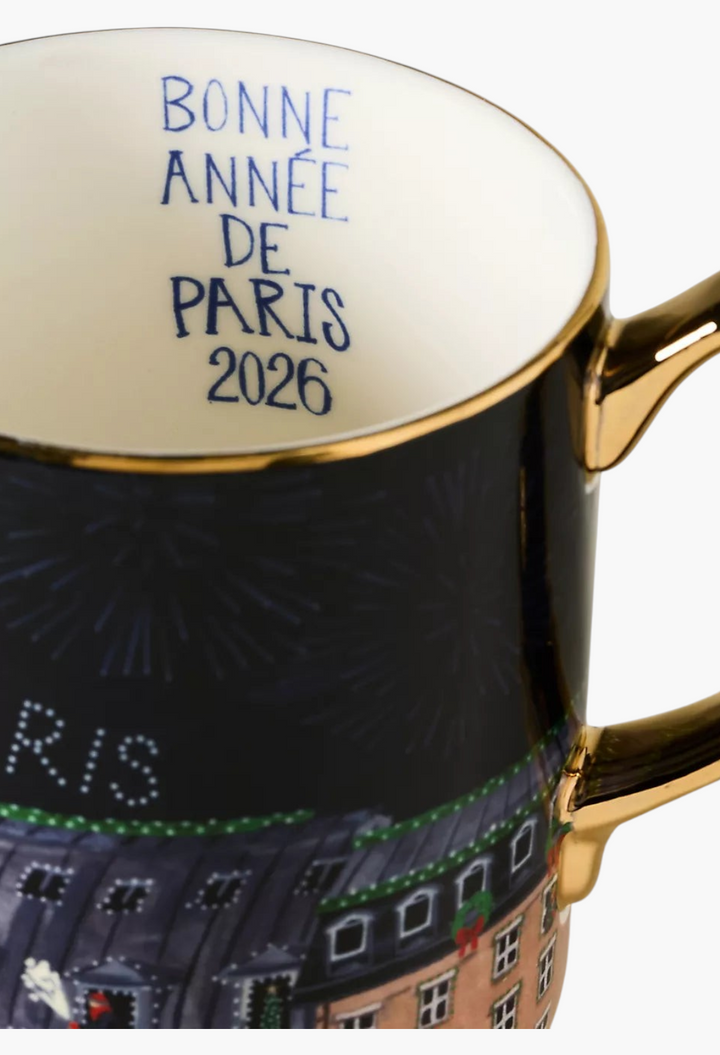 GLAM MODA Holiday in the City stoneware mug featuring a black exterior, gold handle, and Bonne Annee de Paris 2026 text