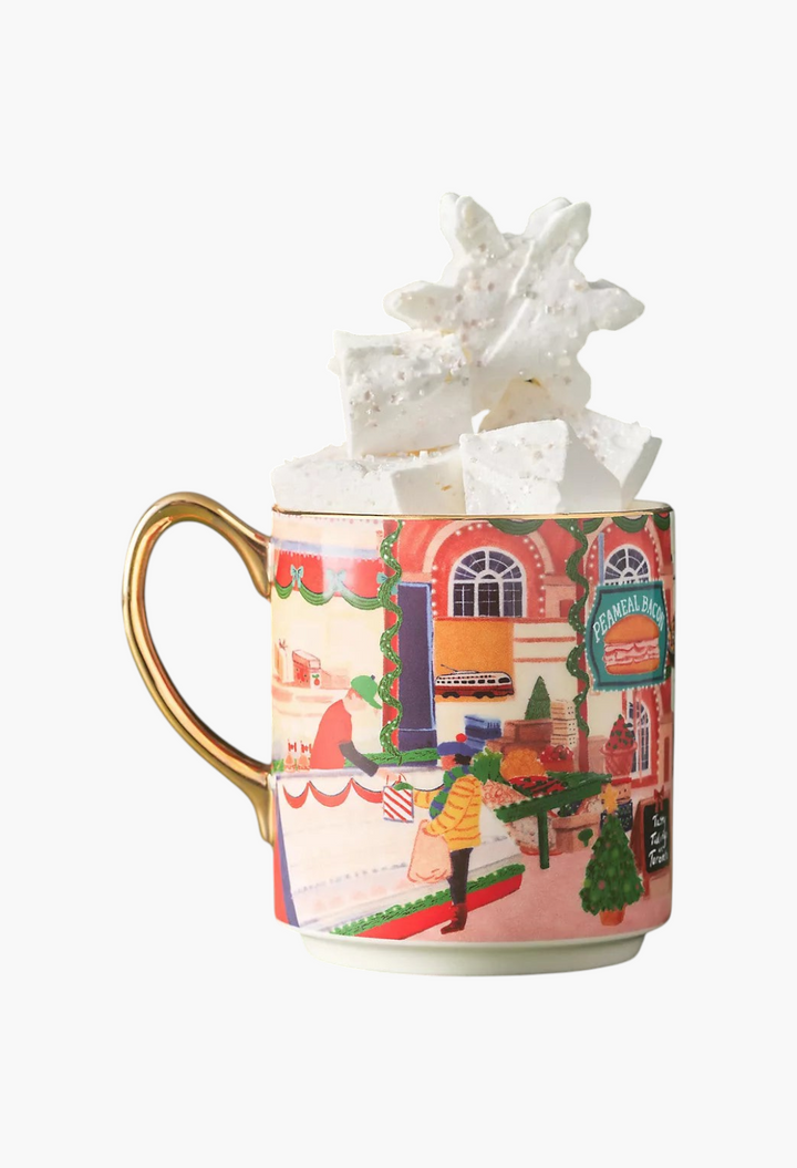 GLAM MODA Holiday in the City stoneware mug featuring a festive streetscape illustration and gold-painted handle.