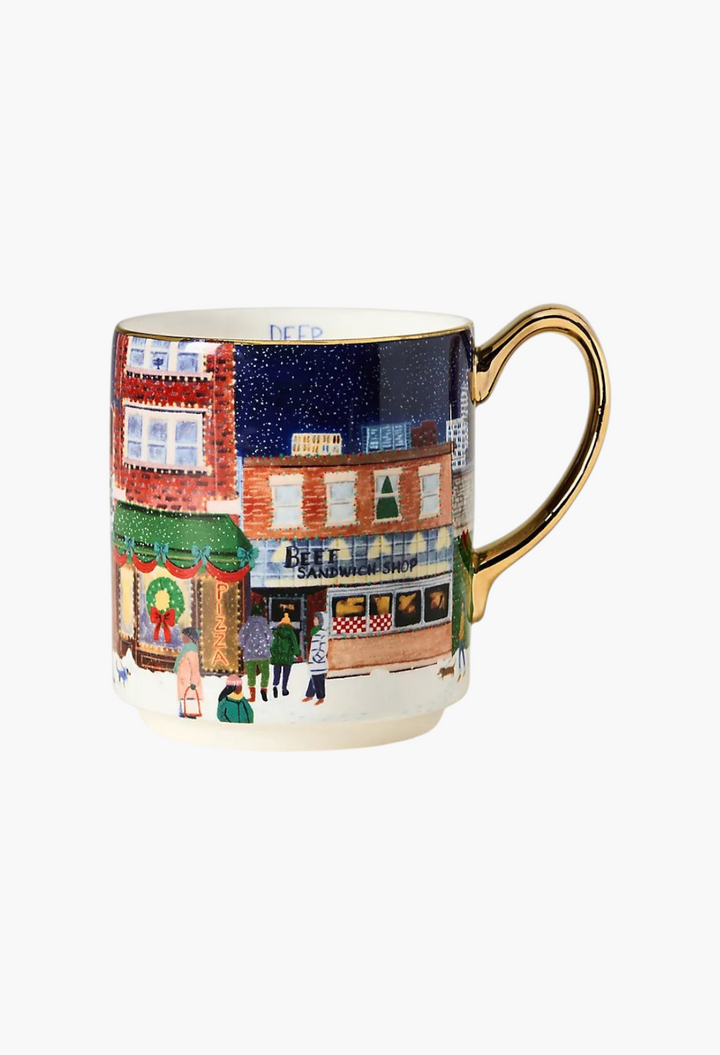 GLAM MODA Holiday in the City stoneware mug featuring a festive snowy streetscape illustration and gold handle.