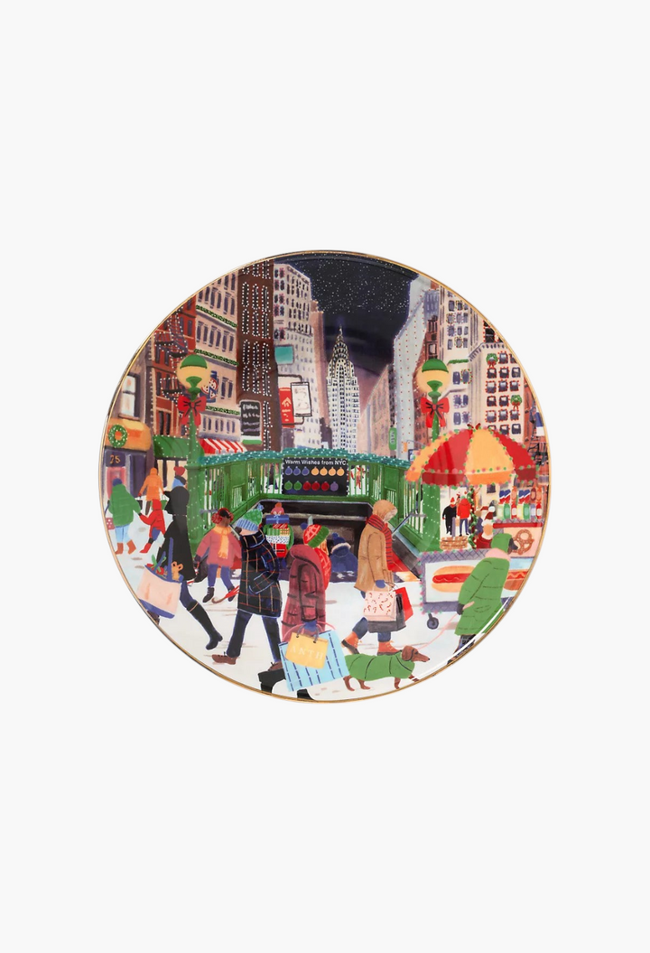 GLAM MODA Holiday in the City stoneware dessert plate featuring a festive New York street scene with gold rim accents.