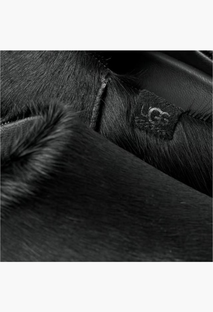 GLAM MODA Otzo black calf hair clog featuring a detailed view of the textured upper and embossed UGG logo leather tag
