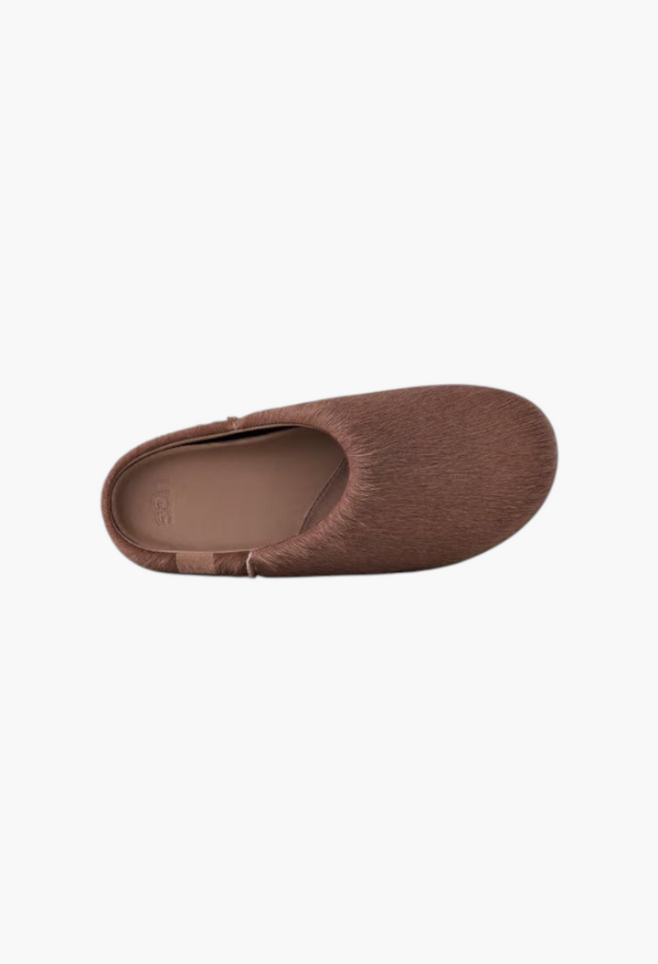GLAM MODA Otzo brown calf hair clog with a contoured footbed and embossed UGG logo, top-down view.