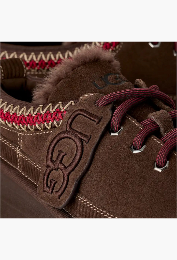GLAM MODA brown suede lace-up slipper featuring UGGbraid trim, sheepskin lining, and a branded logo charm on the tongue