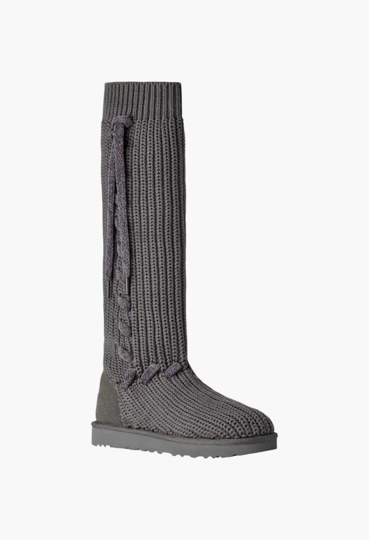 GLAM MODA grey tall knit boot with oversized whipstitch detailing, decorative laces, and a suede heel counter.