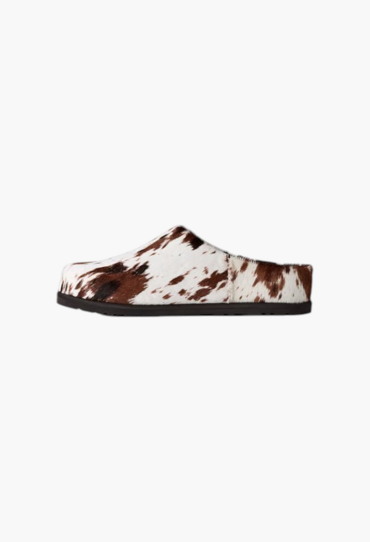 GLAM MODA Otzo Western clog featuring a hand-painted brown and white cow hair upper with a durable rubber outsole.