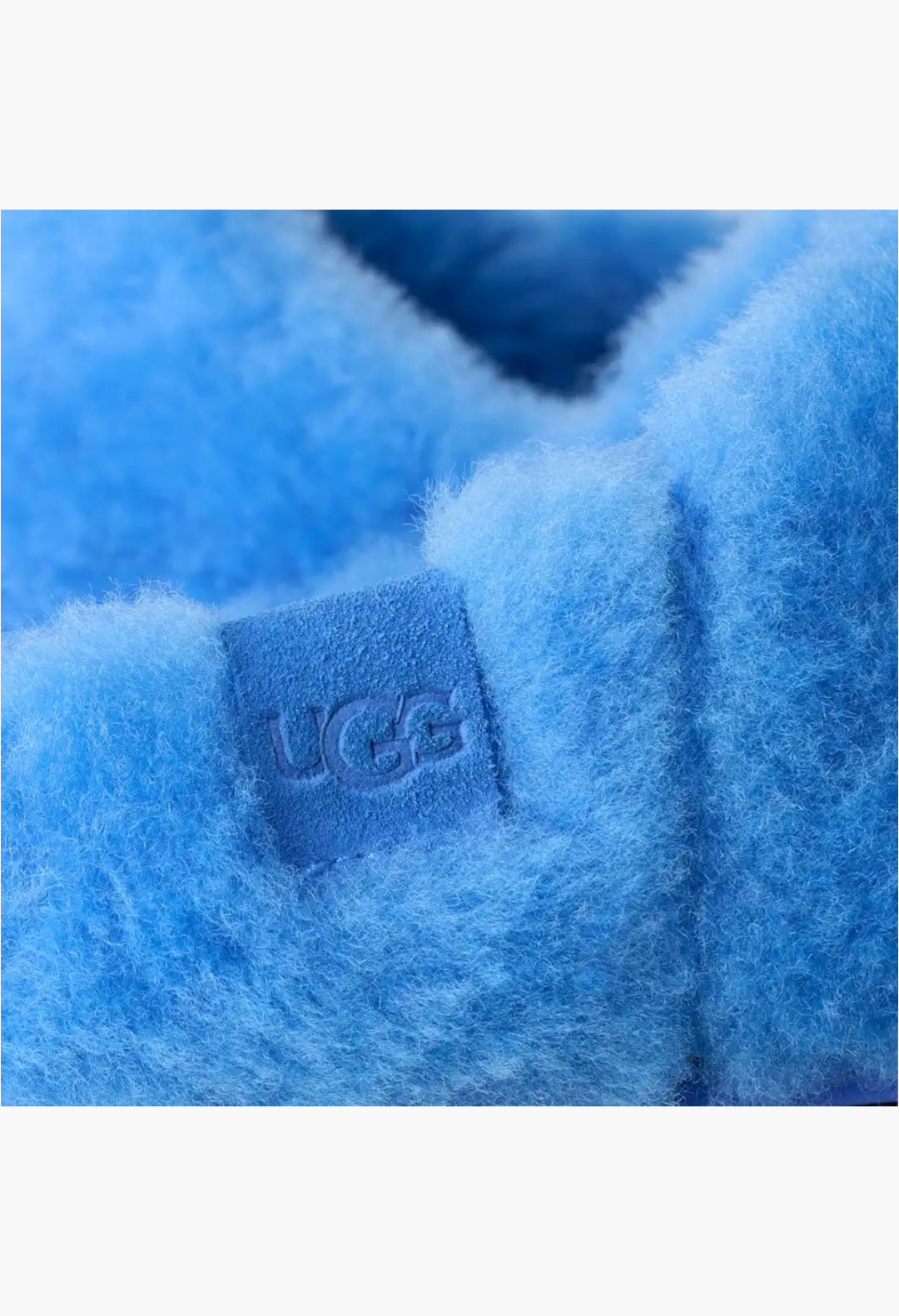 GLAM MODA UGG Elea fluffed slip-on slipper in bright blue sheepskin with embossed suede logo label detail