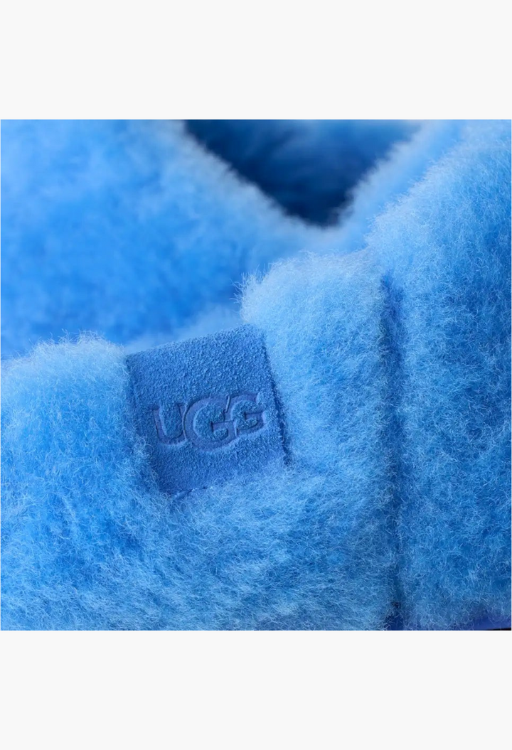 GLAM MODA UGG Elea fluffed slip-on slipper in bright blue sheepskin with embossed suede logo label detail