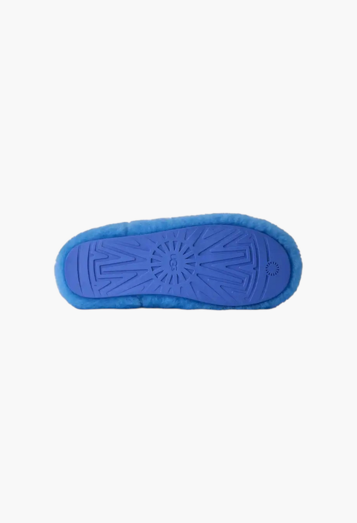 GLAM MODA Elea Fluffed Slip-On slipper showing the bright blue molded rubber outsole with UGG logo tread pattern