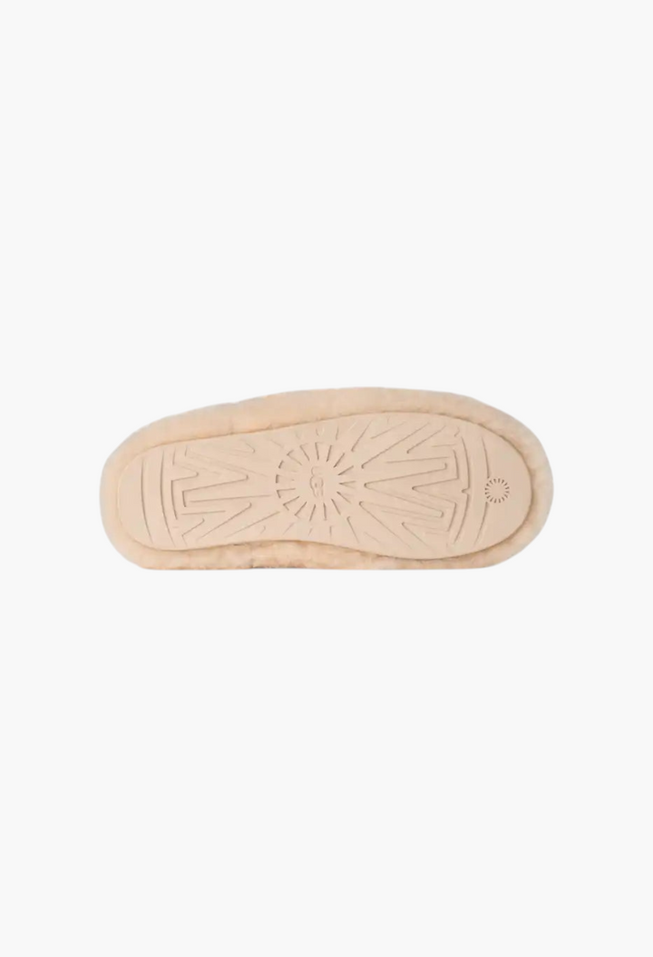 GLAM MODA Elea Fluffed Slip-On beige sheepskin slipper showing the molded rubber outsole with UGG logo pattern