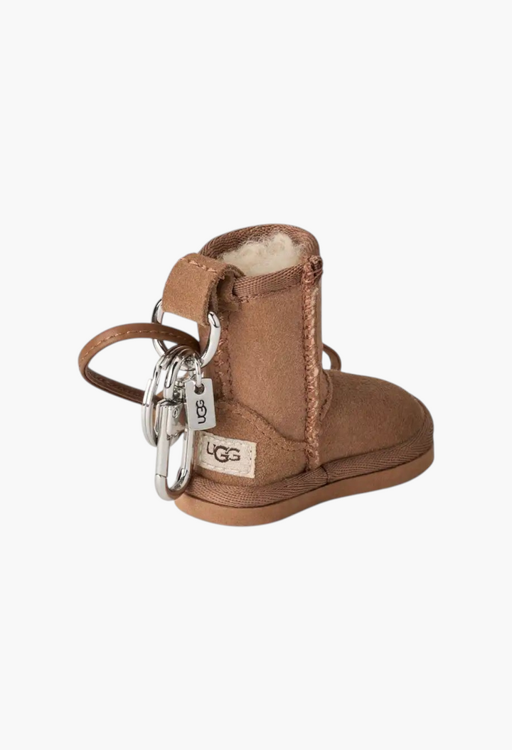 GLAM MODA classic boot charm in chestnut suede with a fluffy sheepskin lining, metal keychain, and UGG logo label.