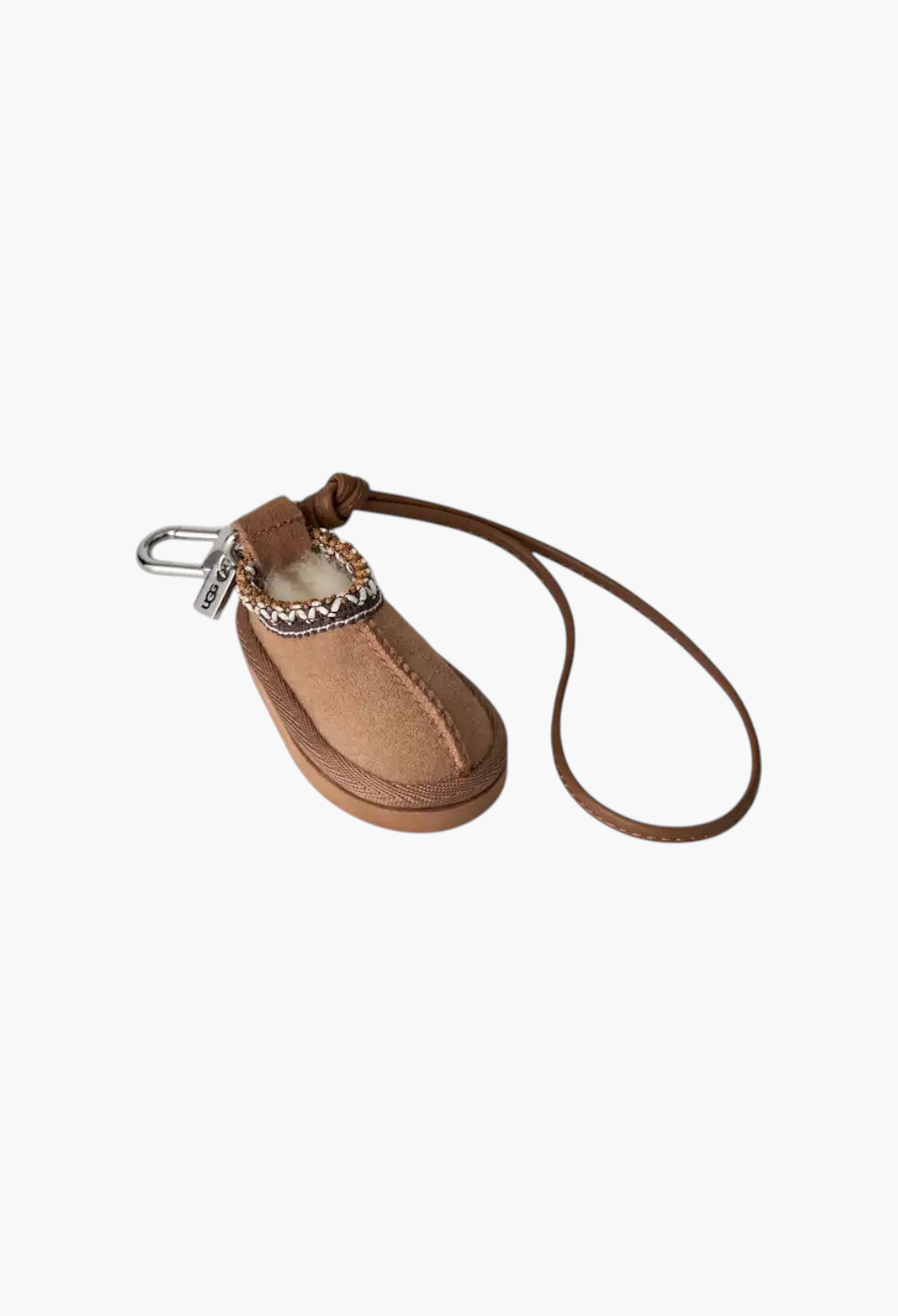 GLAM MODA Tasman slipper charm keychain in chestnut suede with UGGbraid detail, metal ring, and brown leather strap.
