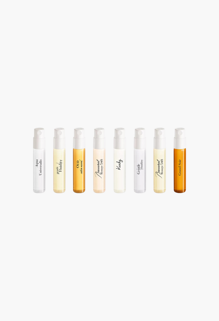 GLAM MODA fragrance discovery set featuring eight travel-size perfume vials with varied amber and clear liquid tones.