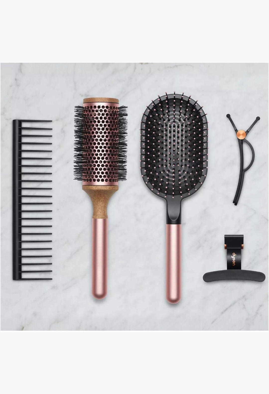 GLAM MODA Dyson Styling Gift Set featuring a detangling comb, vented barrel brush, paddle brush, and hair clips.