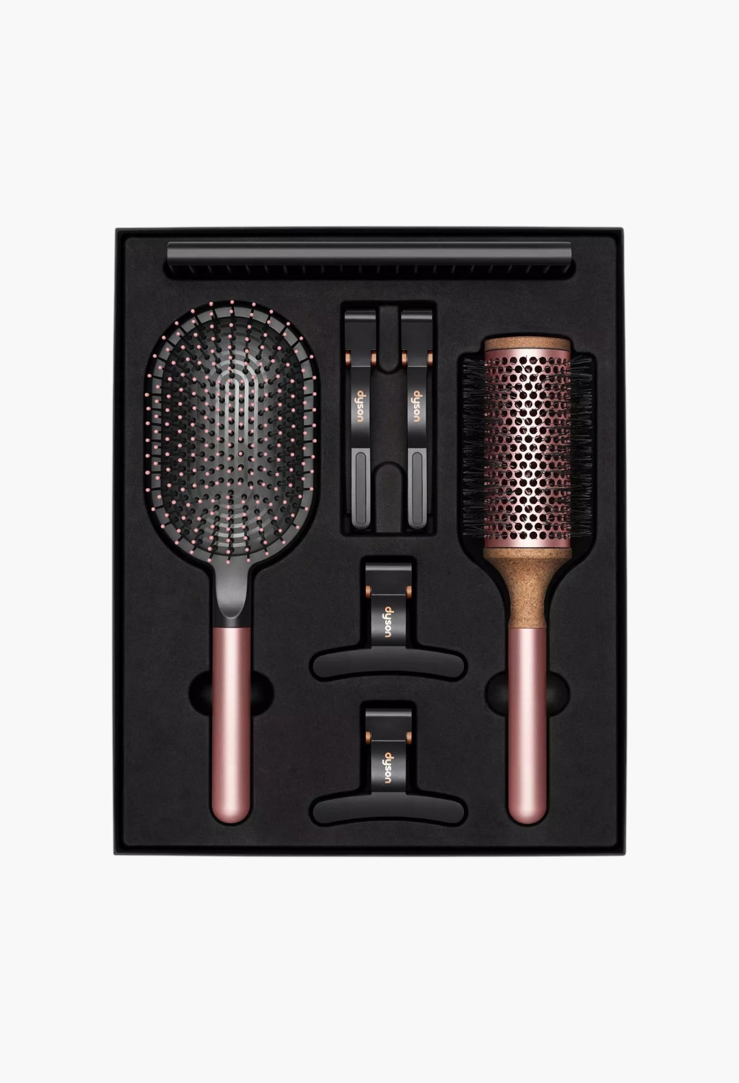 GLAM MODA Dyson Styling Gift Set featuring a paddle brush, vented barrel brush, detangling comb, and four hair clips.