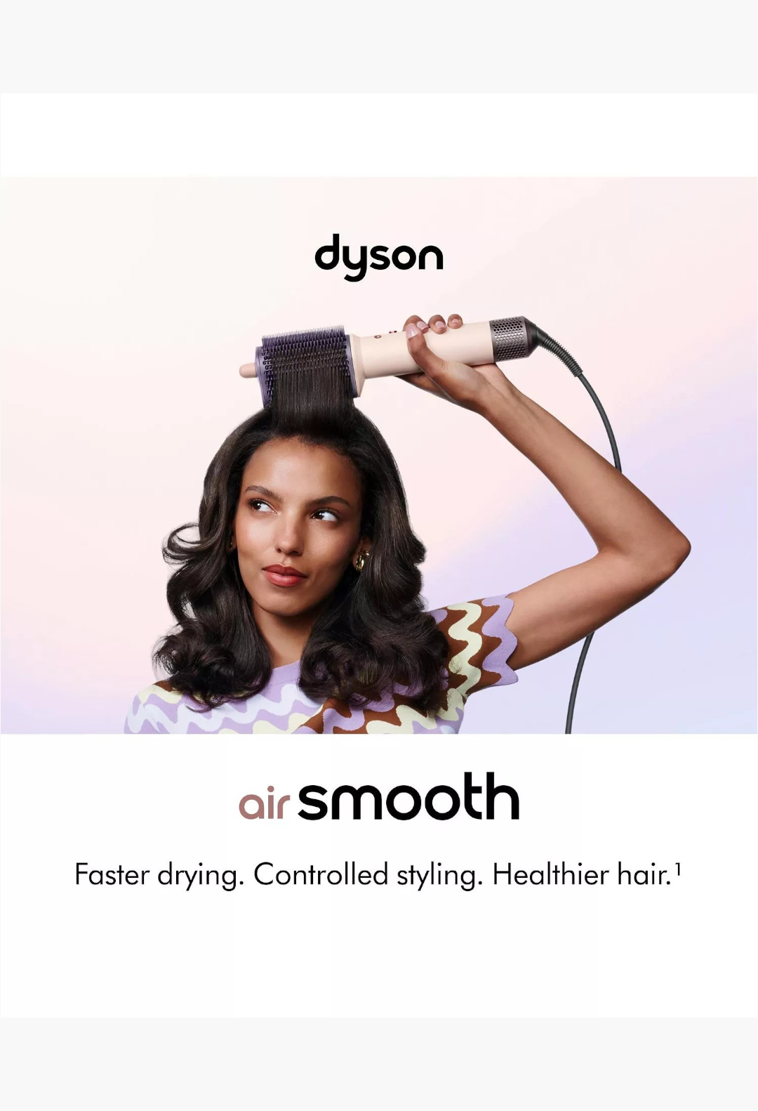 GLAM MODA Dyson Airsmooth styling brush in ceramic pink and rose gold being used by a woman to style her hair