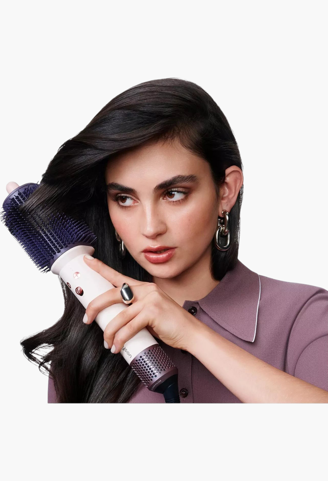 GLAM MODA Dyson Airsmooth styling brush in pink and rose gold being used by a woman to style her long dark hair