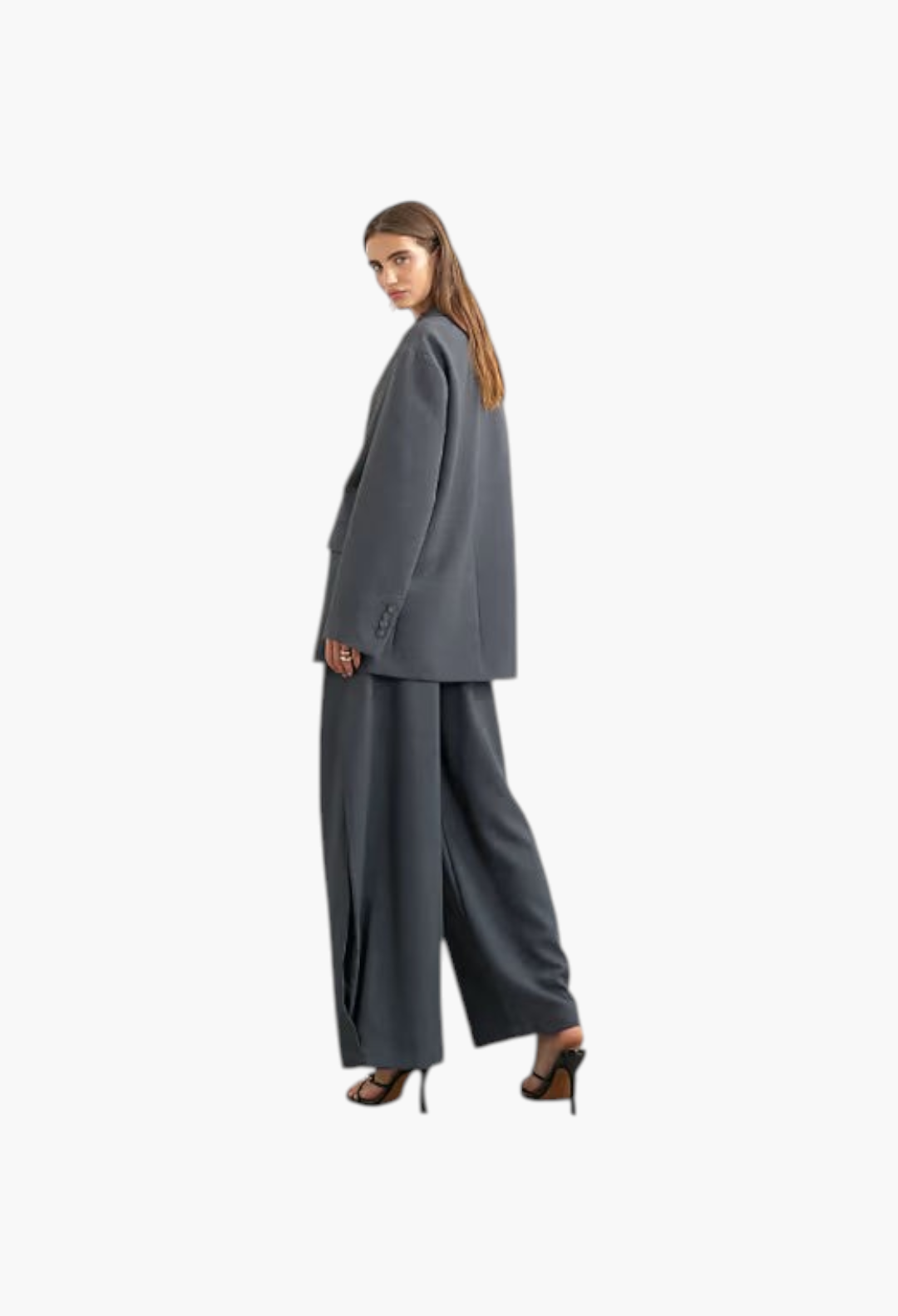 GLAM MODA model wearing grey woven ovoid trousers with side pleats and a matching blazer against a white background