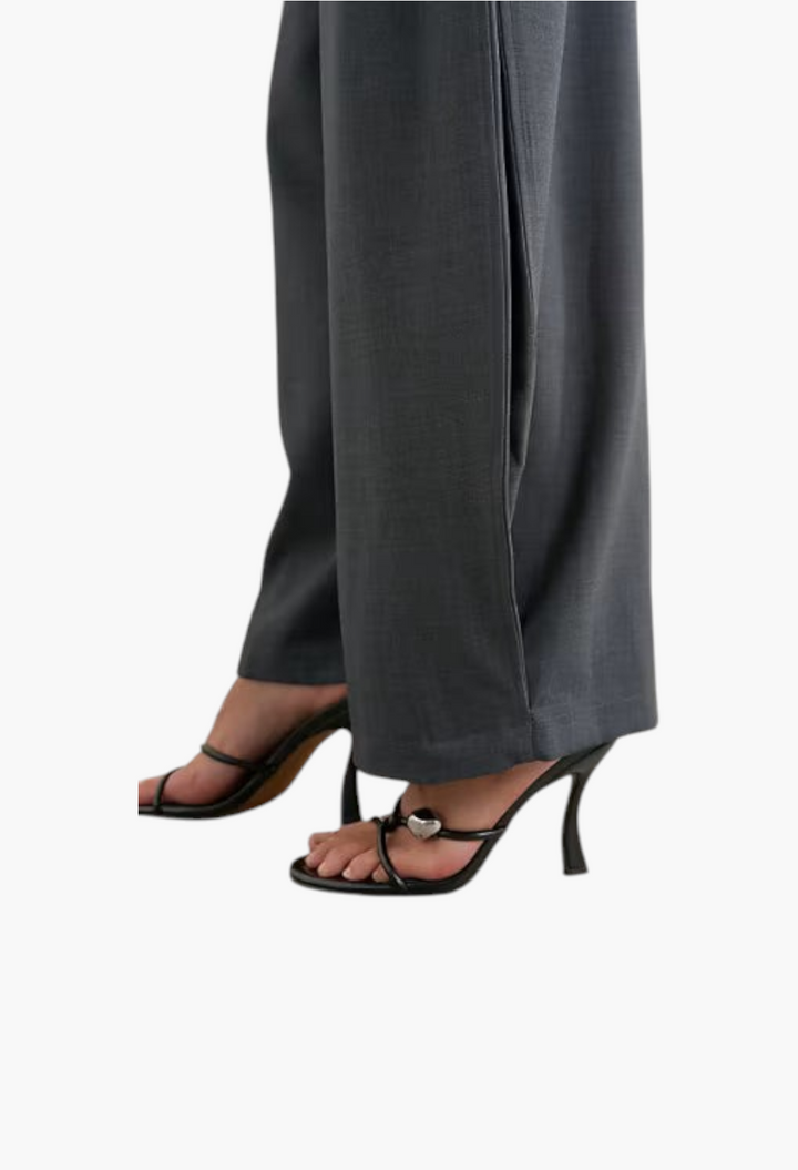 GLAM MODA grey woven barrel leg trousers with side pleats worn with black strappy high heels