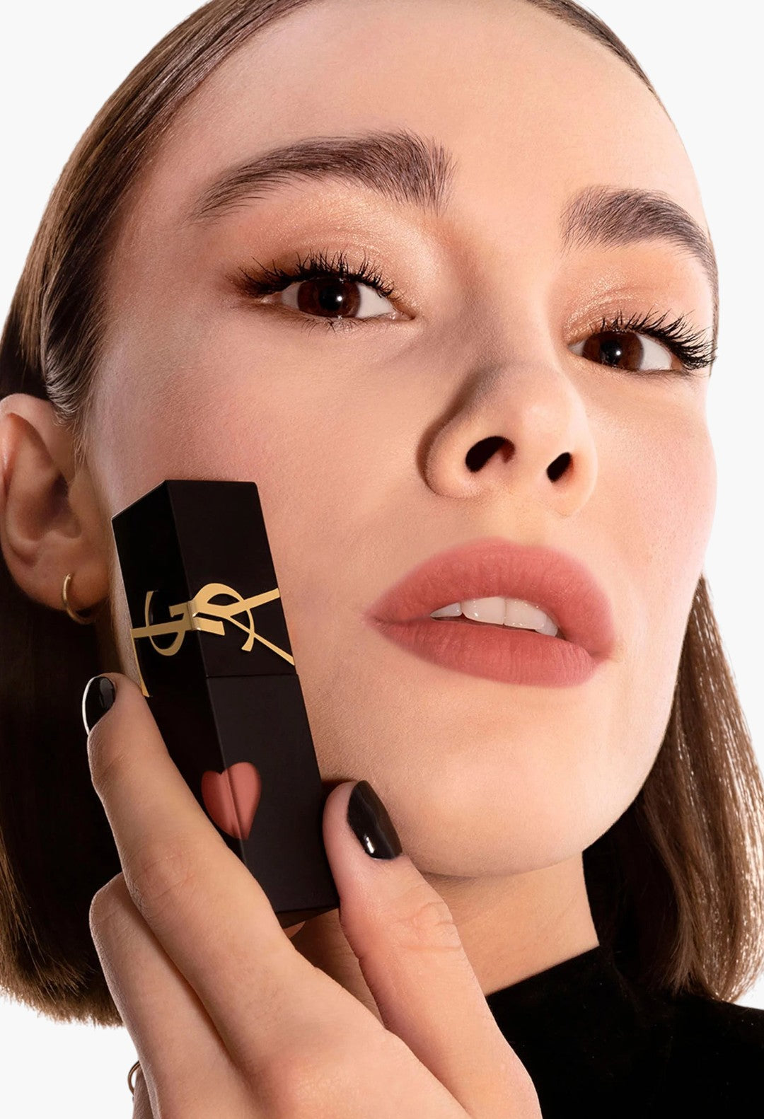 GLAM MODA Yves Saint Laurent The Inks Blurring Matte Liquid Lip Stain in a soft nude shade held by a model