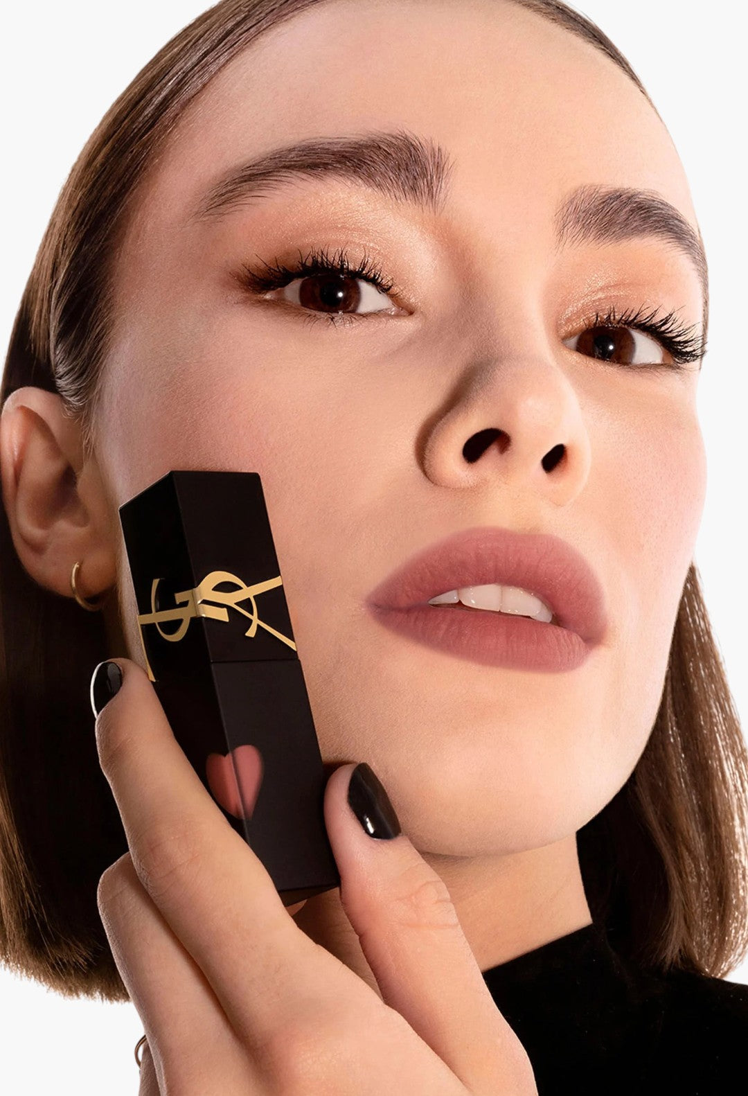 Model holding GLAM MODA Yves Saint Laurent The Inks Blurring Matte Liquid Lip Stain with a soft mauve matte finish