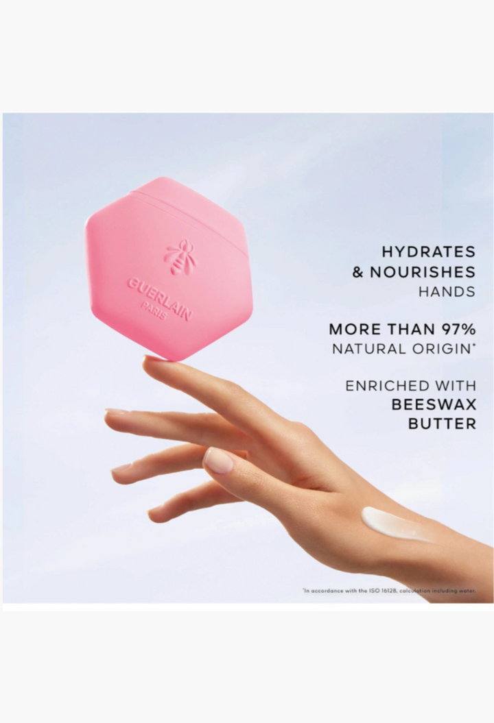 GLAM MODA Guerlain Aqua Allegoria Florabloom hand cream in a pink honeycomb tube with a dab of cream on a hand