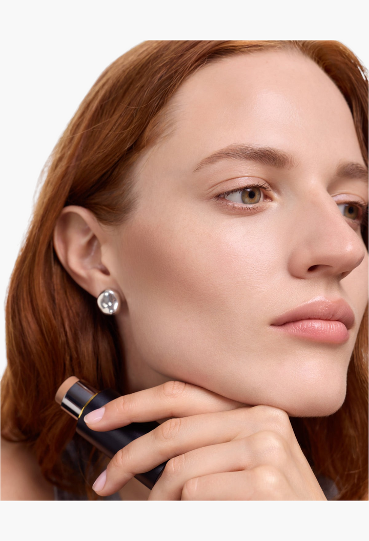 GLAM MODA Face Trace Contour Stick applied to a model's cheekbone for a natural, creamy, and defined shadow effect.