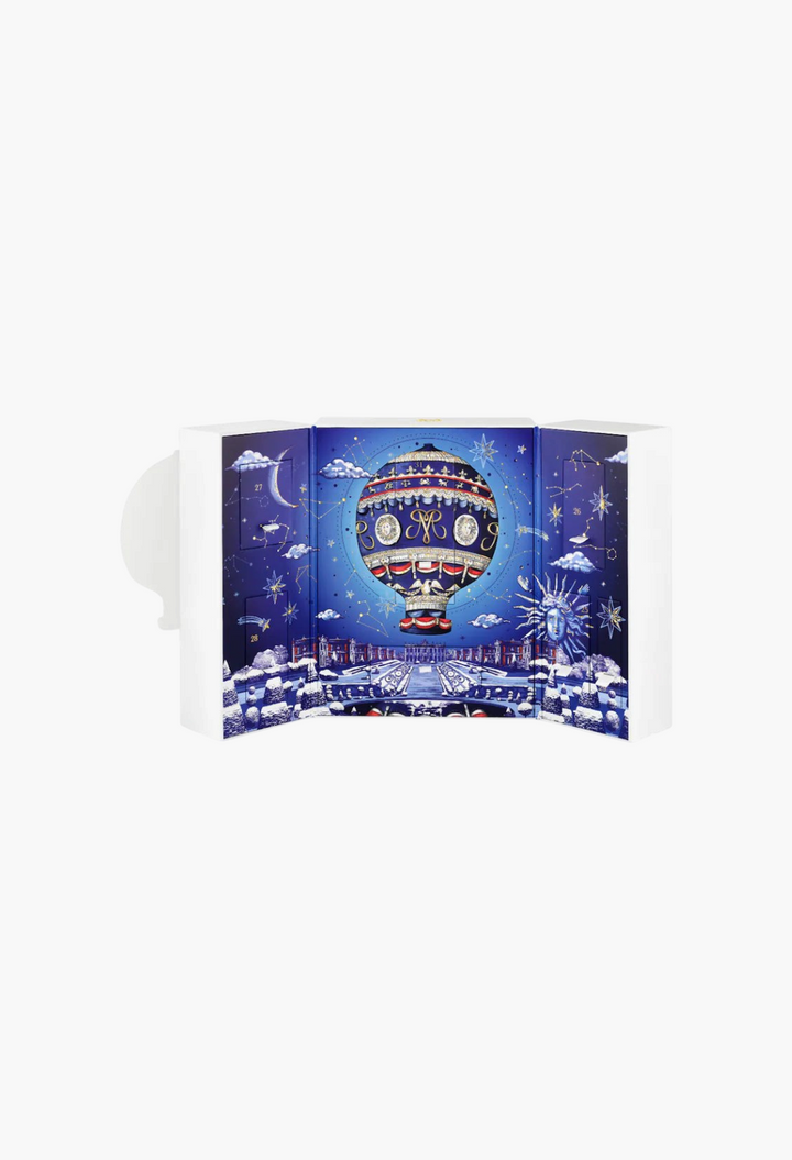 GLAM MODA Countdown perfume advent calendar featuring a celestial hot-air balloon illustration on a blue background.