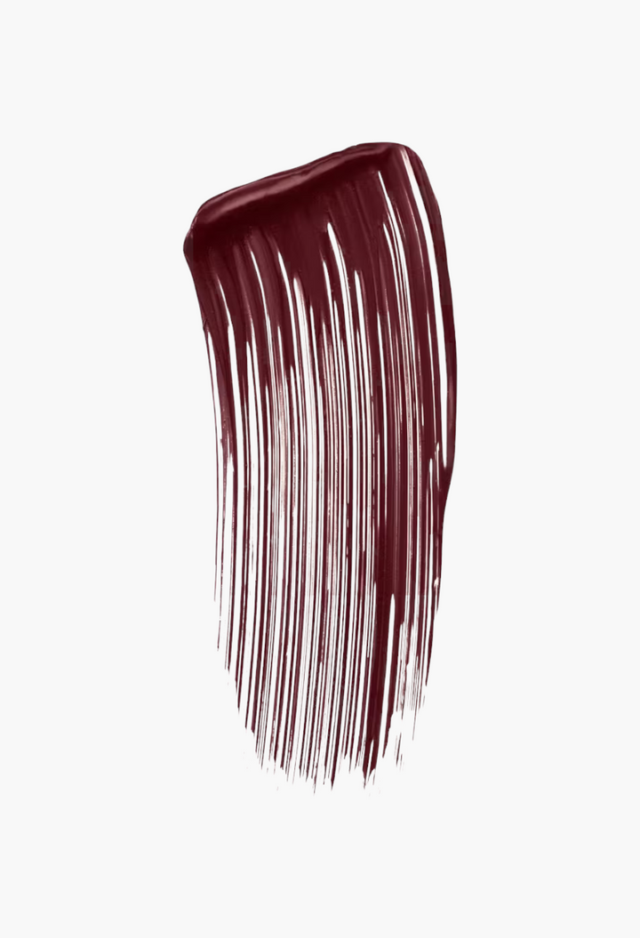 GLAM MODA swatch of dark burgundy volumizing mascara showing smooth, buildable texture and rich pigment.