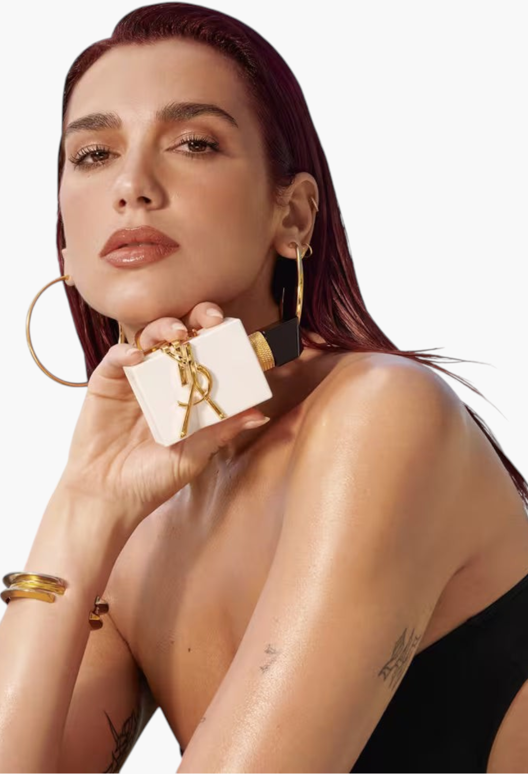GLAM MODA model holding a white Yves Saint Laurent Libre L’eau Nue perfume bottle with gold logo against a plain background