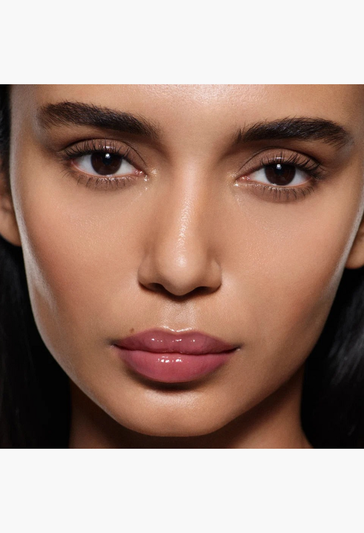 GLAM MODA Posh Gloss High Shine Lip on a model with a natural makeup look and glossy, hydrated, mauve-toned lips.