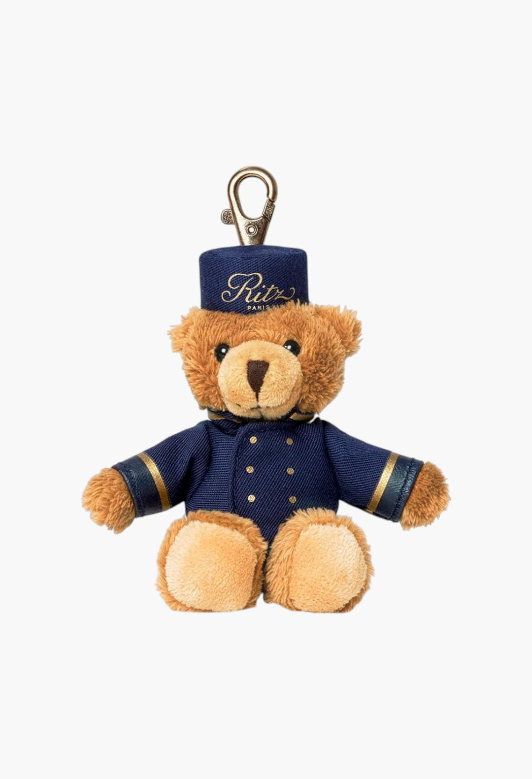 GLAM MODA Ritz Paris teddy bear bellboy key ring in brown plush with a blue uniform and gold details.