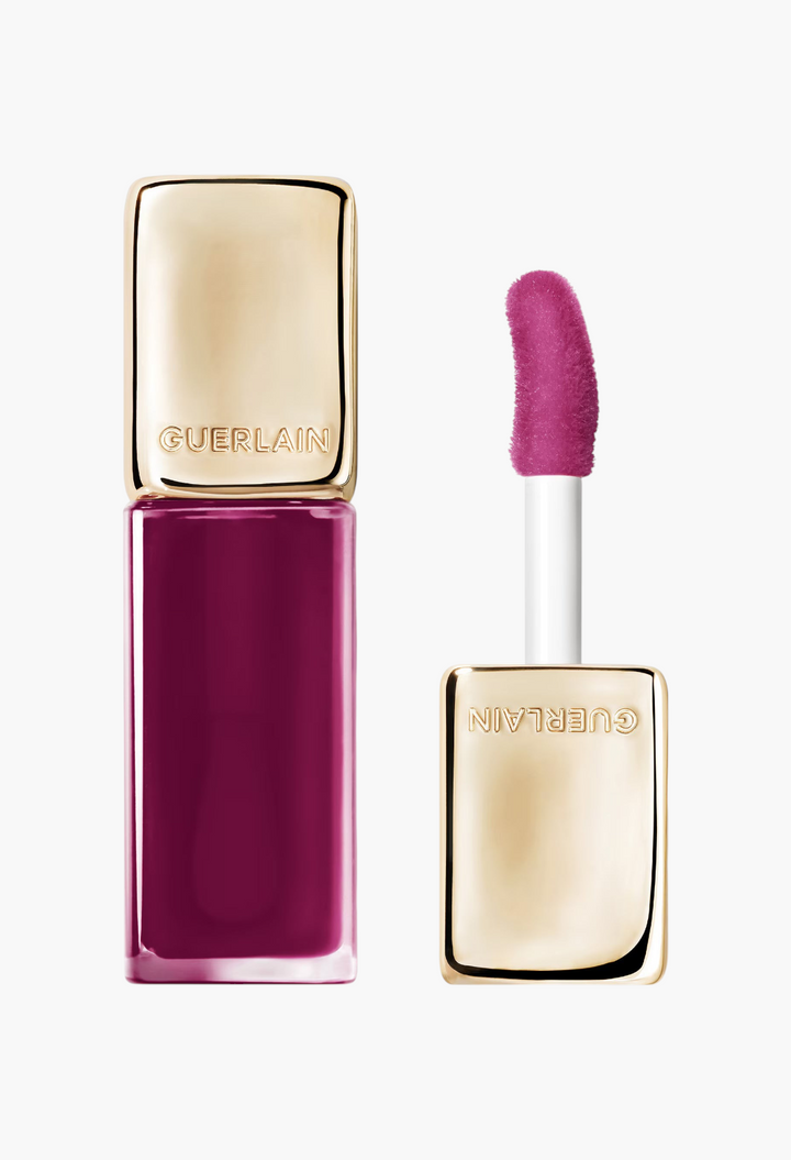 GLAM MODA Guerlain KissKiss Bee Glow Oil in Lavender Glow, a plum tinted lip oil with a gold cap and applicator.