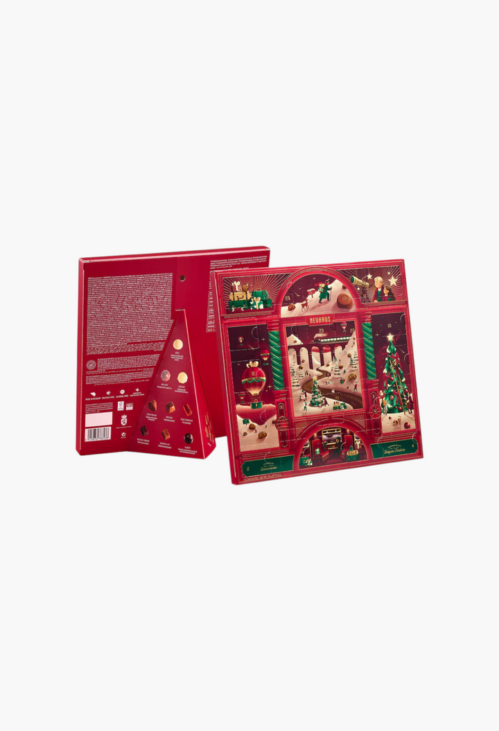 GLAM MODA Neuhaus chocolate advent calendar featuring festive red packaging with holiday illustrations and praline details.