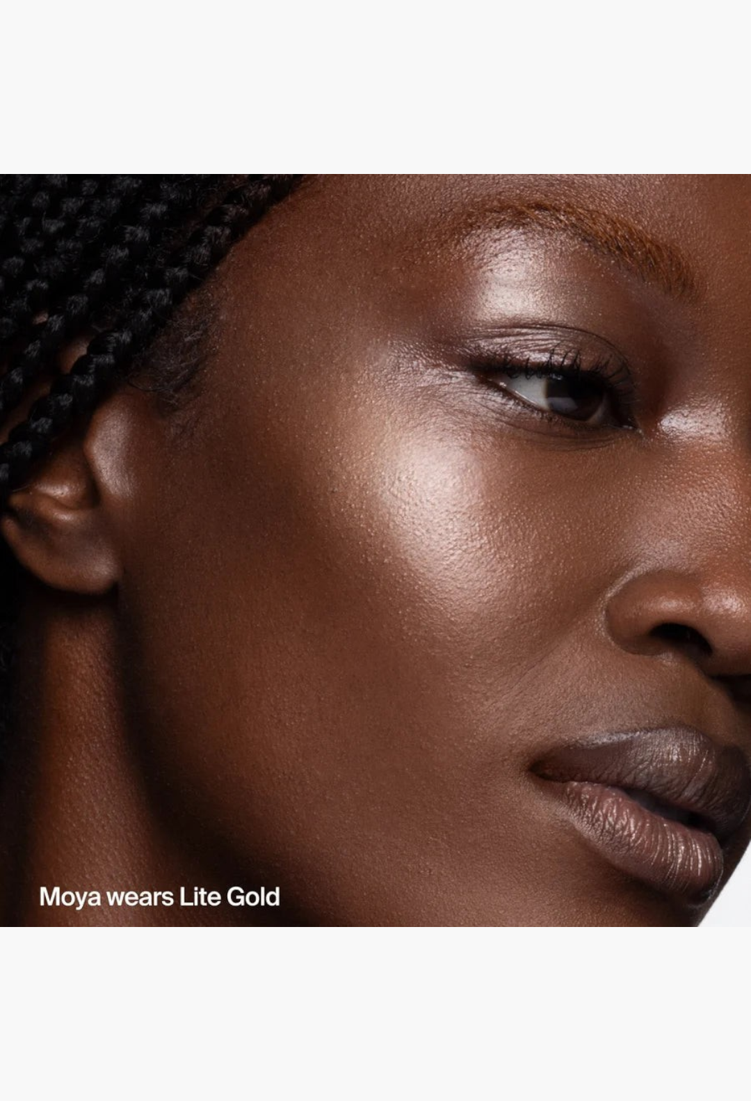 GLAM MODA Hyper Shine Lite Pigment in Lite Gold shade applied to a model's cheekbone for a radiant luminous glow