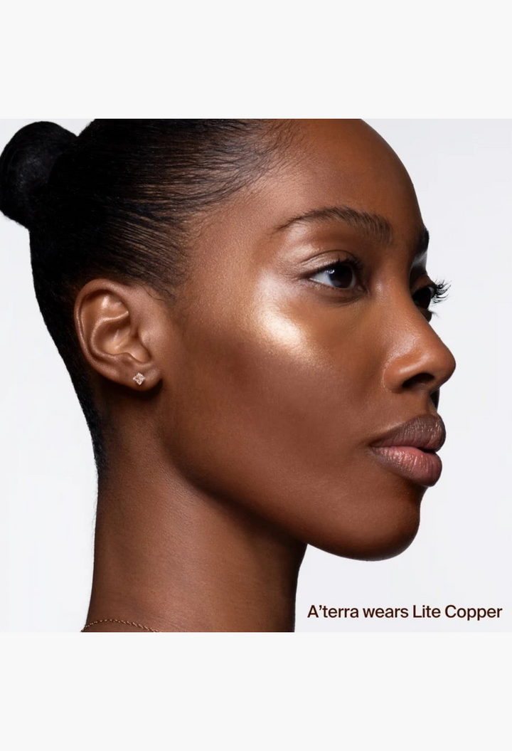 GLAM MODA Hyper Shine Lite Pigment applied to the cheekbone of a model for a radiant, lit-from-within glow.