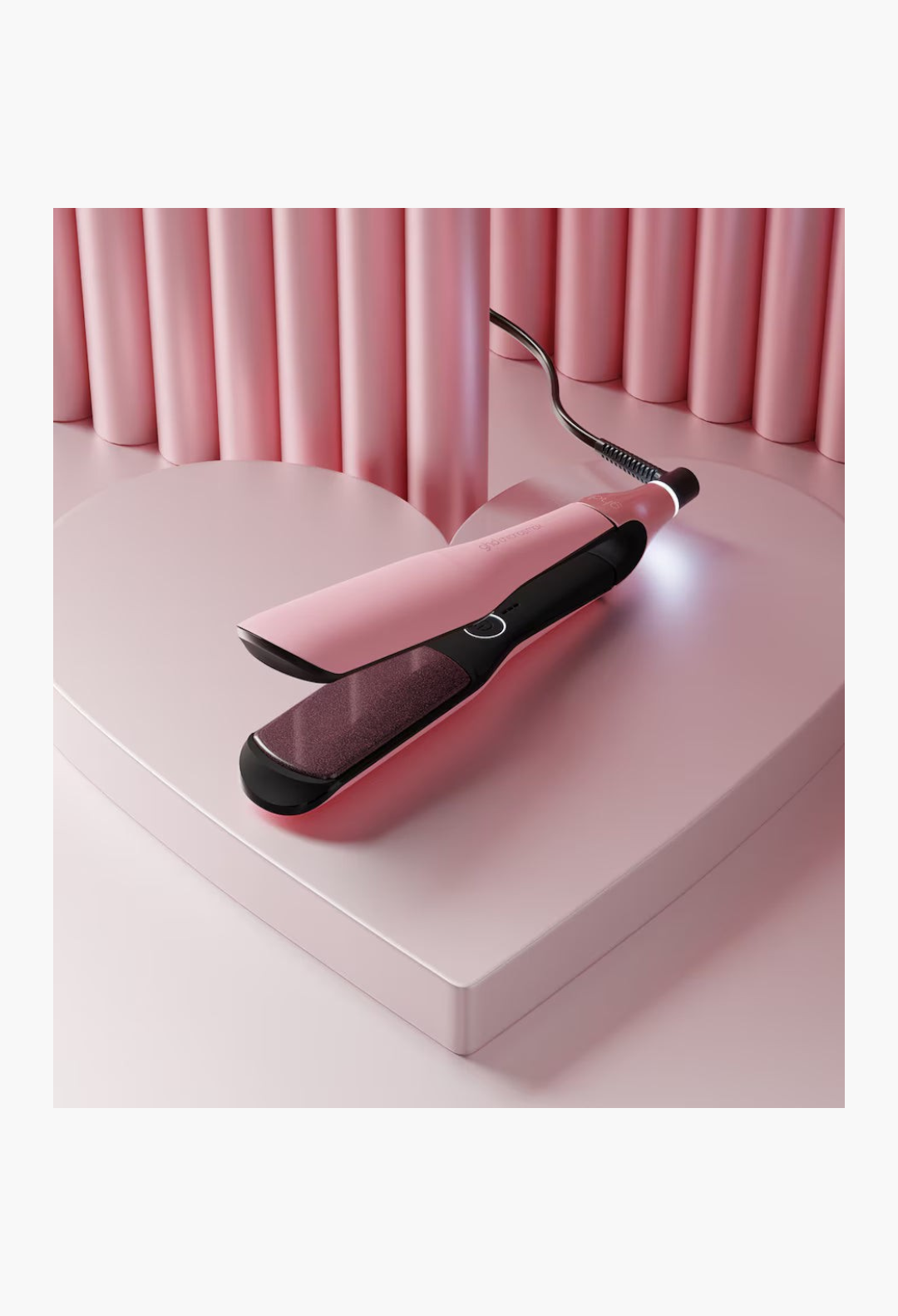GLAM MODA Pink Collection Chronos Max wide plate hair straightener in blush pink on a heart-shaped display stand.