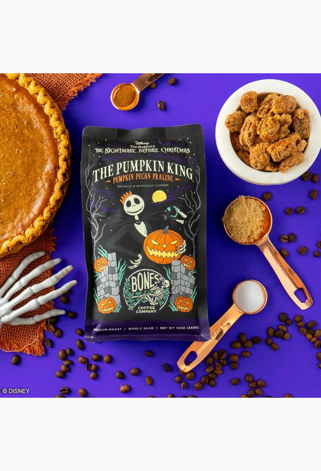 GLAM MODA Bones Coffee Company Pumpkin King medium roast coffee bag with pumpkin pie, pecans, and skeleton hand prop.