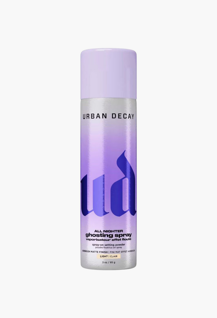 GLAM MODA Urban Decay All Nighter Ghosting Spray travel size setting powder in a silver and purple aerosol bottle.