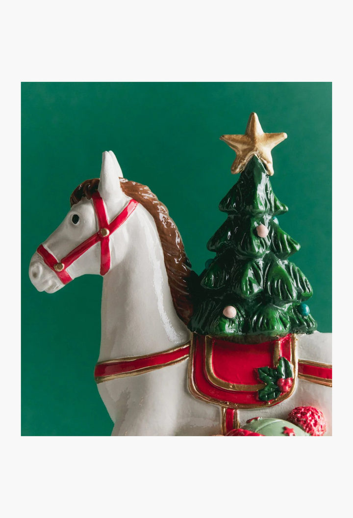 GLAM MODA ceramic rocking horse advent calendar with a decorated Christmas tree and gold star on a green background