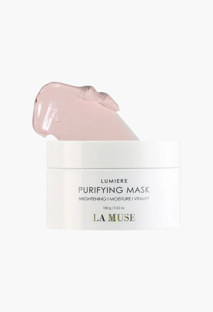GLAM MODA La Muse Lumiere Purifying Mask in a white jar with a soft pink clay texture scoop on top